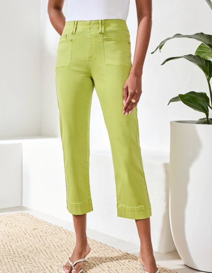 Person wearing bright green pants in a minimal indoor setting