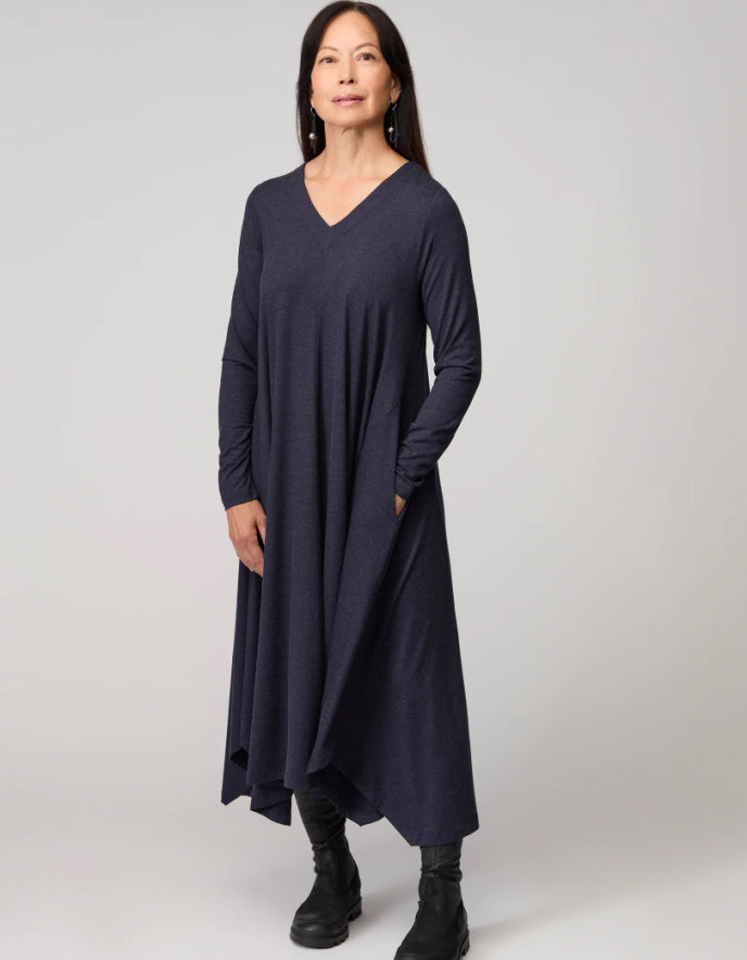 Woman wearing a long navy dress on a white background