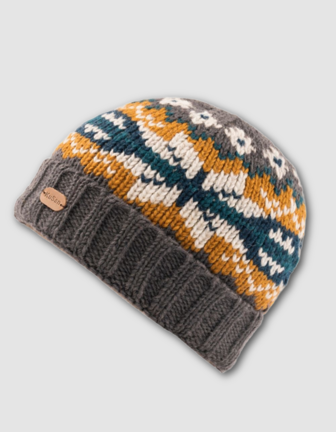Knitted beanie with geometric snowflake pattern on a light grey background