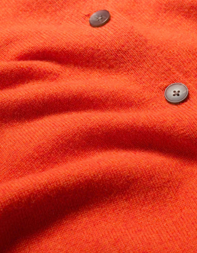 Close-up of orange fabric with buttons