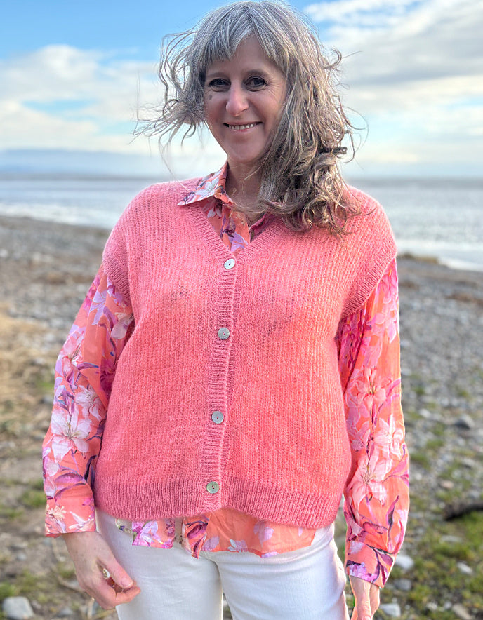 knitted wool tank waistcoat worn over a floral cotton blouse in peach and pink florals