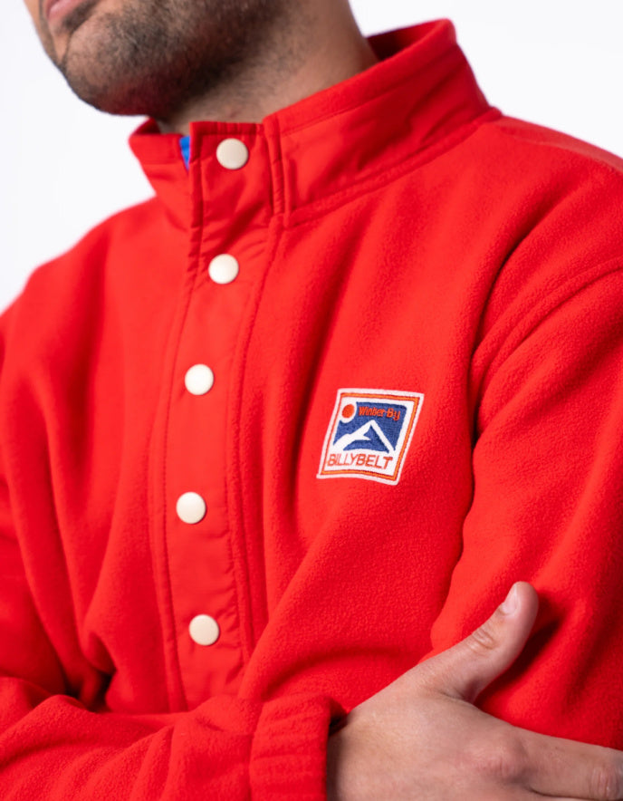 Red jacket with a logo on the chest against a white background