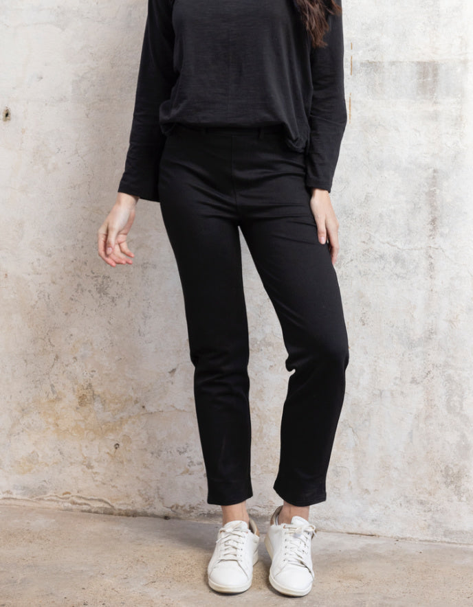 lady wearing black stretch straight leg pull on trousers