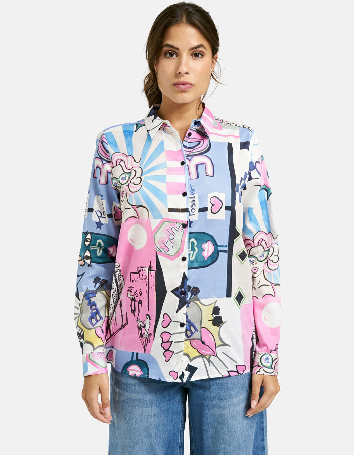 Woman wearing a colorful patterned shirt with a white background
