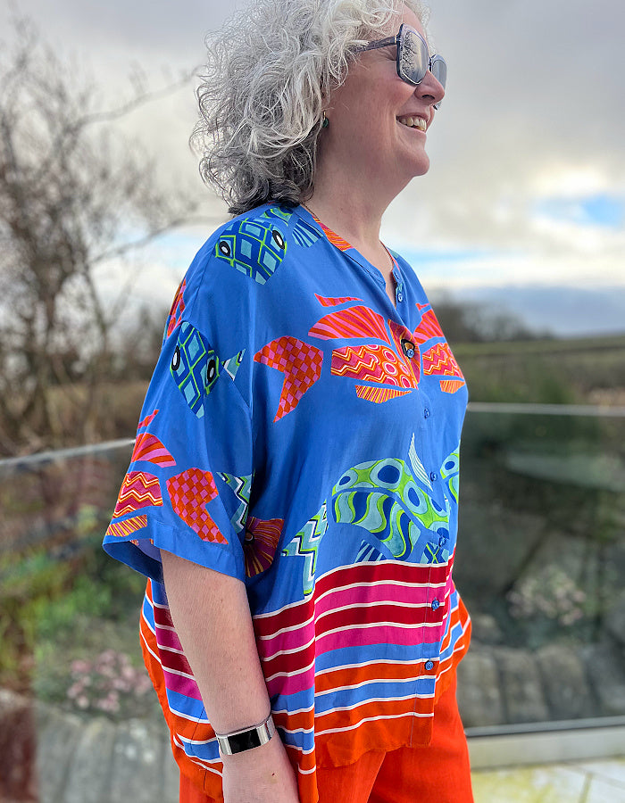 oversized viscose summer shirt with elbow length sleeves and simple round collar with hot colours and an abstract fish print