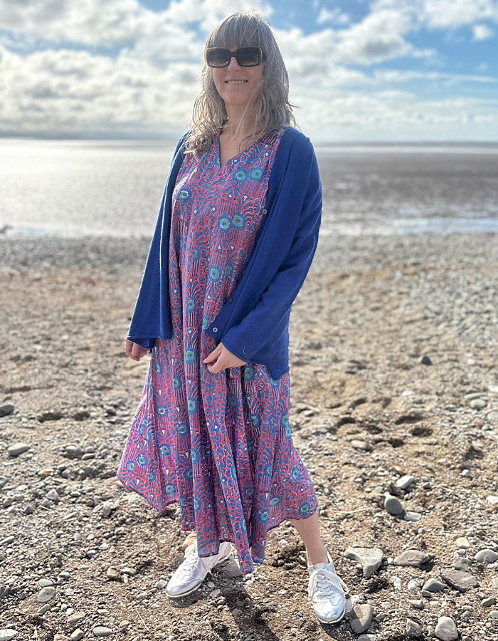 midi length cotton dress with full skirt and pockets and 3/4 length sleeves and V neckline in red and blue hand blocked print