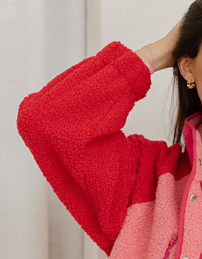 Close-up of a red fleece jacket with a blurred background