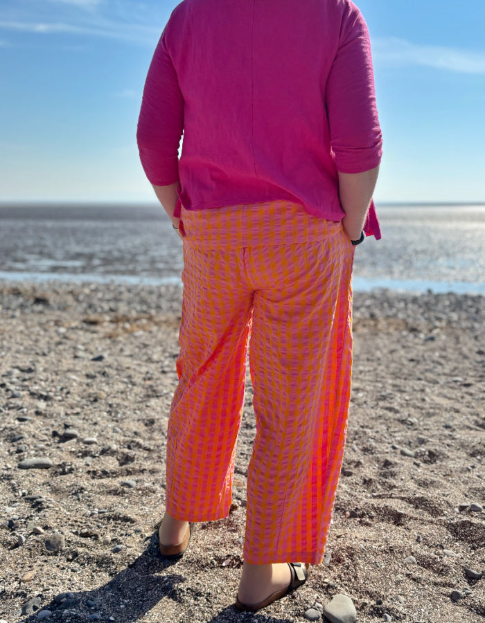 pink and orange lantern shaped cotton summer trousers with elasticated waist and pockets