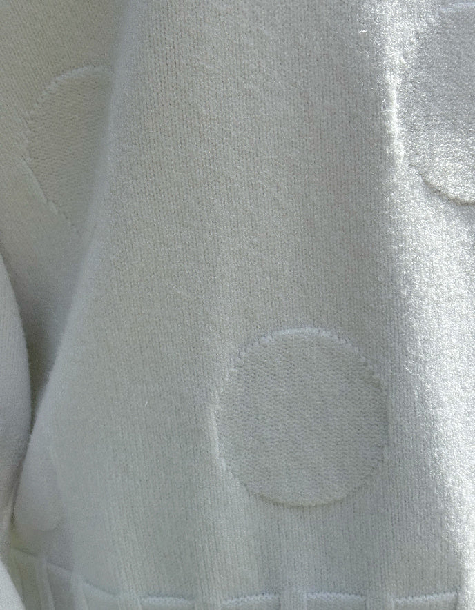 Close-up of a textured light gray fabric with circular patterns