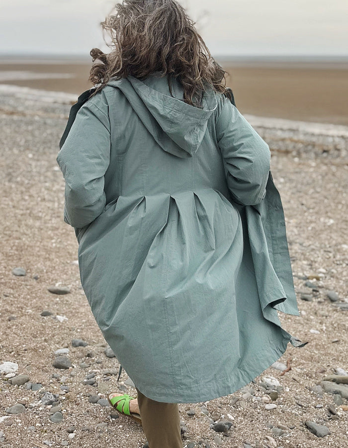 cotton hooded duster coat in soft duck egg blue, two front pockets and button front and pleated back for a swing shape