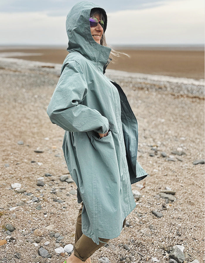 cotton hooded duster coat in soft duck egg blue, two front pockets and button front and pleated back for a swing shape