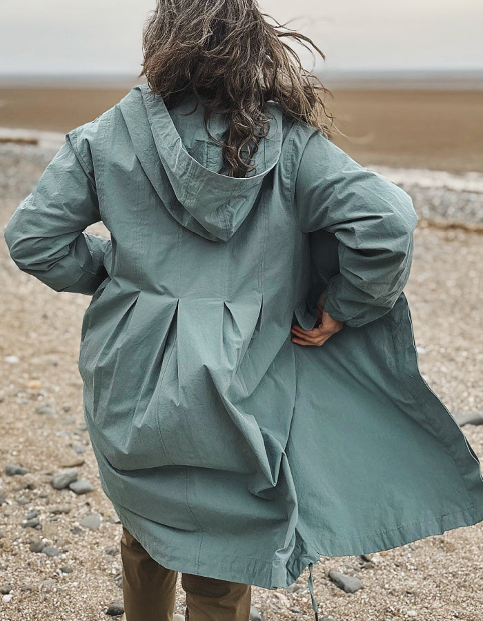 cotton hooded duster coat in soft duck egg blue, two front pockets and button front and pleated back for a swing shape
