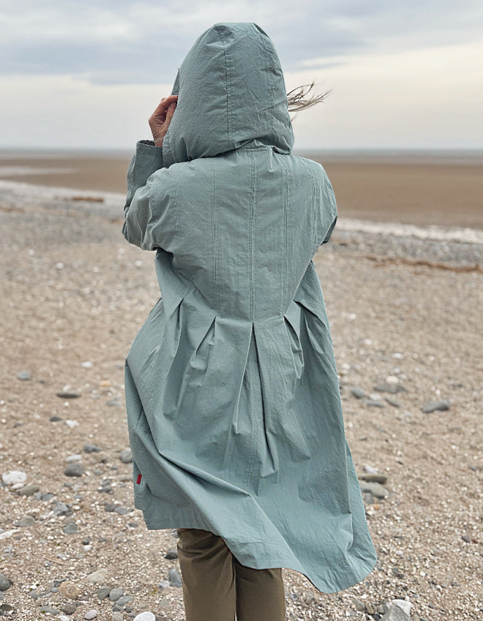 cotton hooded duster coat in soft duck egg blue, two front pockets and button front and pleated back for a swing shape