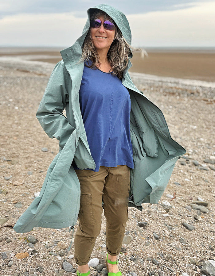 cotton hooded duster coat in soft duck egg blue, two front pockets and button front and pleated back for a swing shape