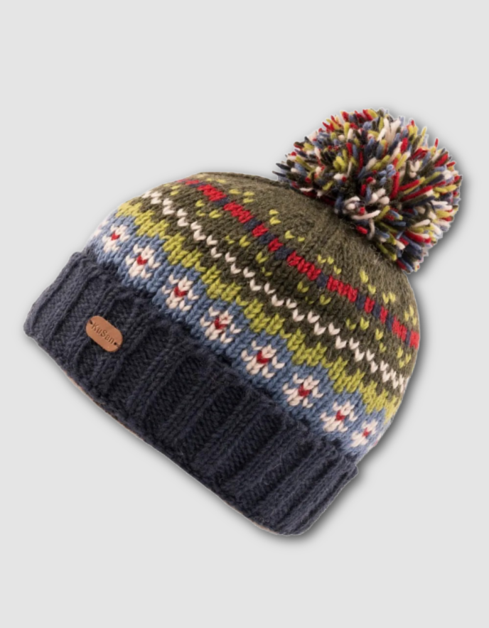 Knitted beanie with colorful pattern and pom-pom on a light gray background