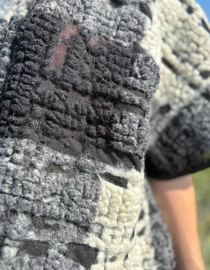Close-up of textured fabric with a blurred natural background