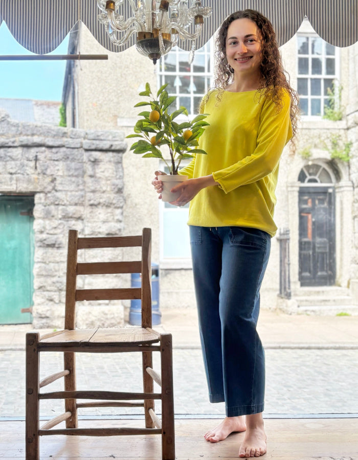 yellow cotton sweater with 3/4 length sleeves and boat neckline