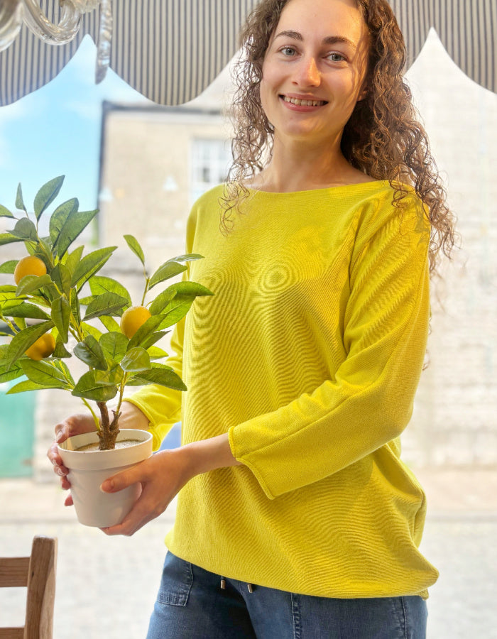 yellow cotton sweater with 3/4 length sleeves and boat neckline