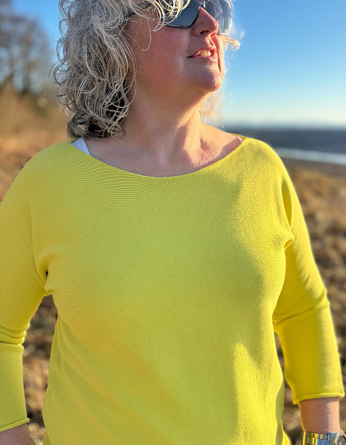yellow cotton sweater with 3/4 length sleeves and boat neckline