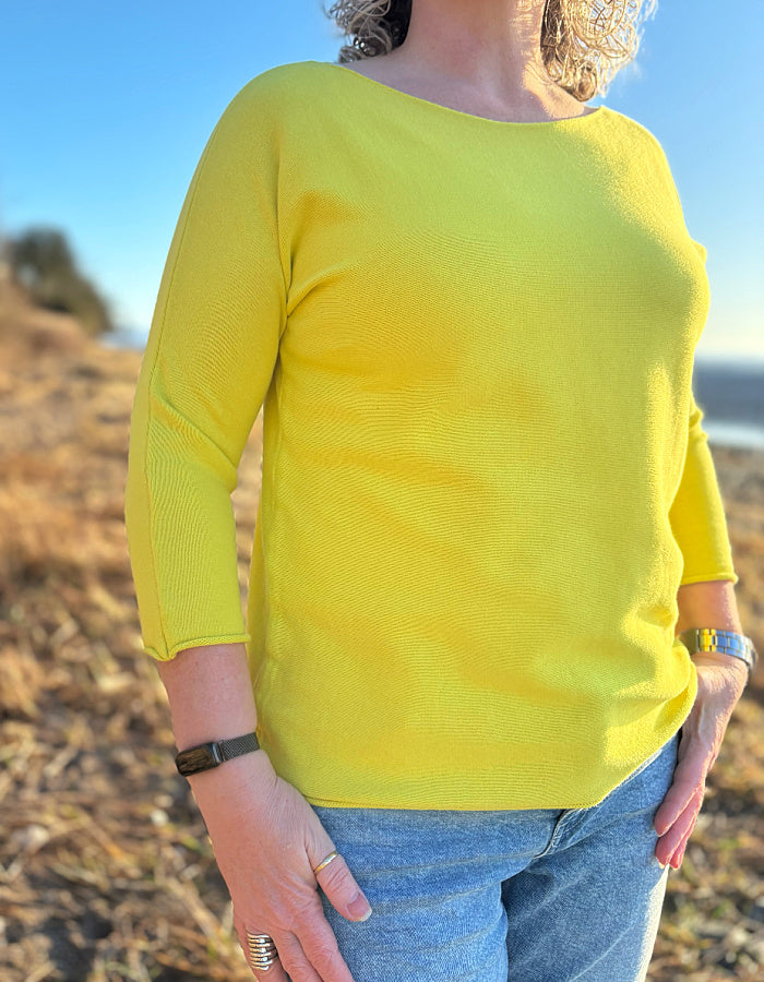yellow cotton sweater with 3/4 length sleeves and boat neckline