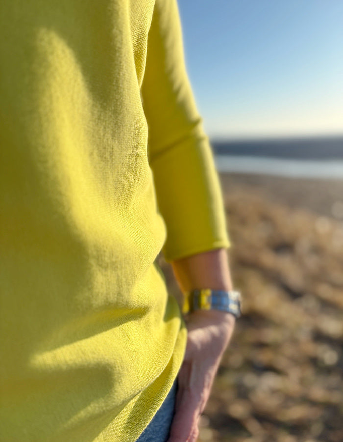yellow cotton sweater with 3/4 length sleeves and boat neckline