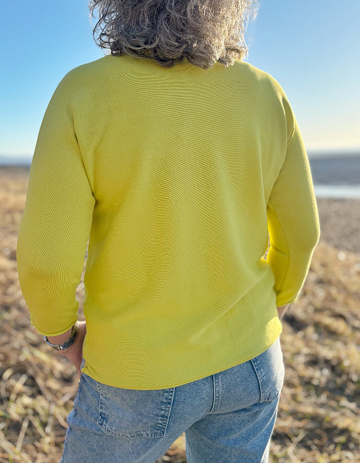 yellow cotton sweater with 3/4 length sleeves and boat neckline