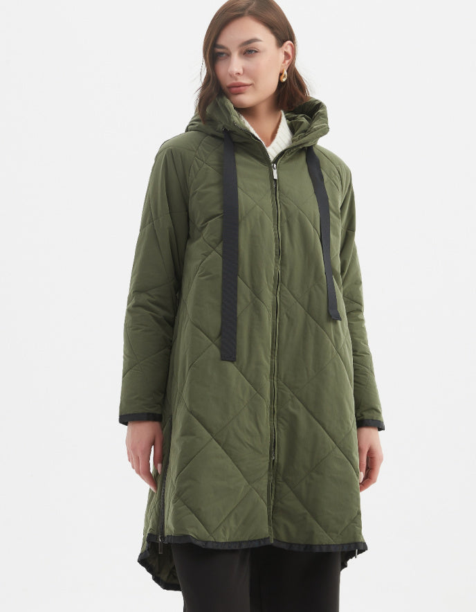 Woman wearing a green quilted coat on a white background
