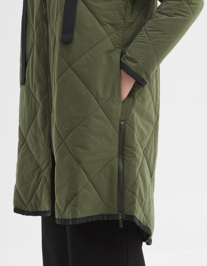 Green quilted jacket with black accents on a white background