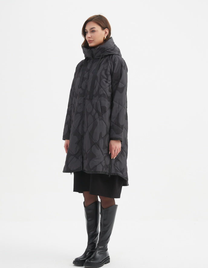 Woman wearing a black patterned coat and black boots on a white background