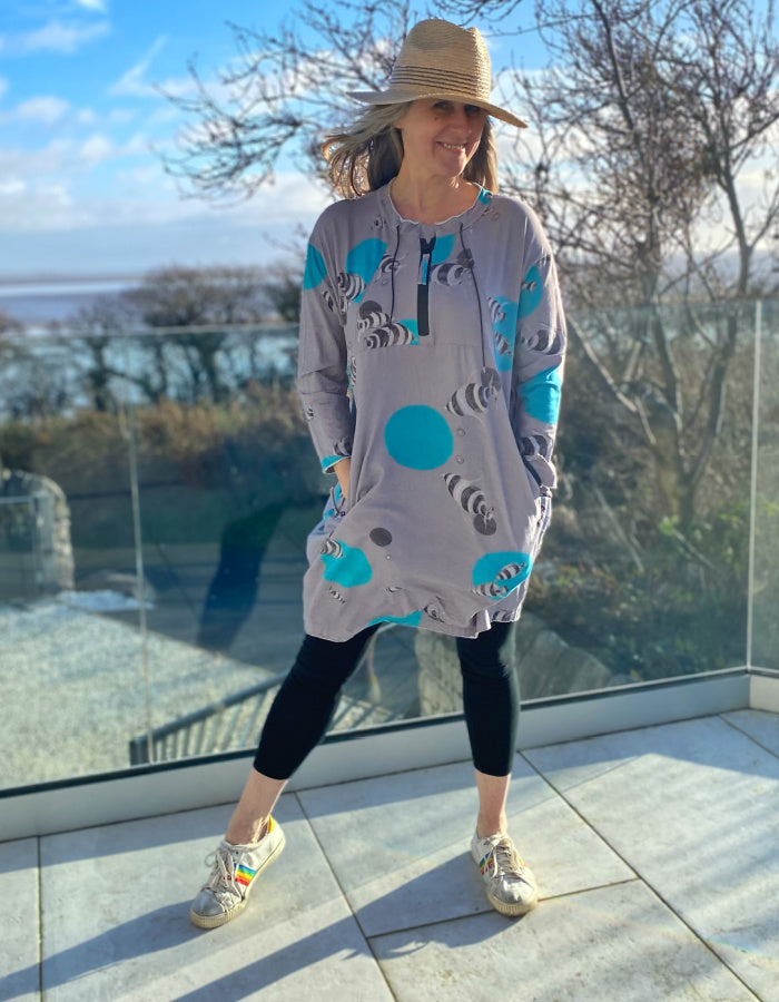 grey cotton stretch jersey tunic with turquoise fish print and half zip, two pockets with zip closure