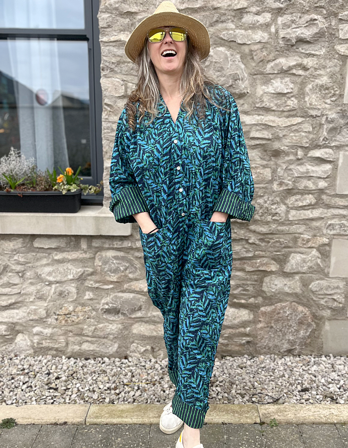 all in one cotton jumpsuit with button up front, 3/4 length sleeves in blue and green fern print with striped turn ups on cuffs and hems