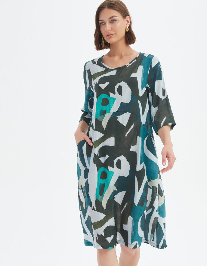 Woman wearing a patterned dress on a white background