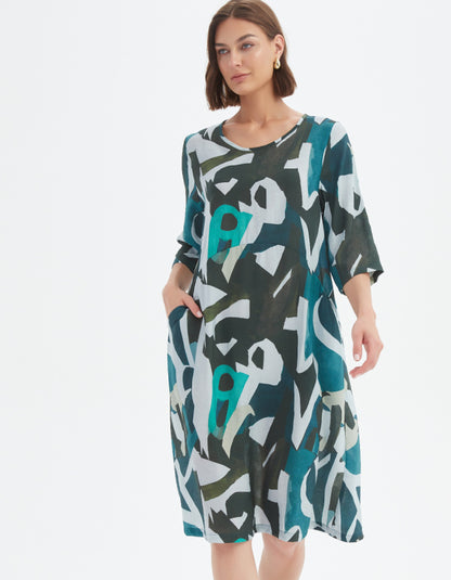 Woman wearing a patterned dress on a white background