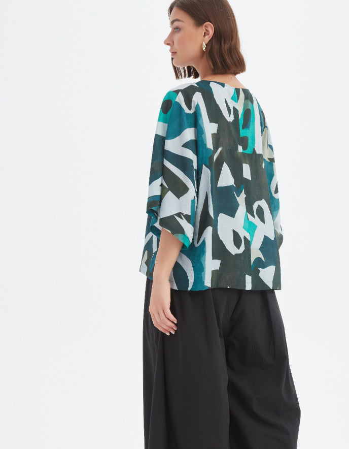 woman wearing abstract print boxy fit summer top in teals
