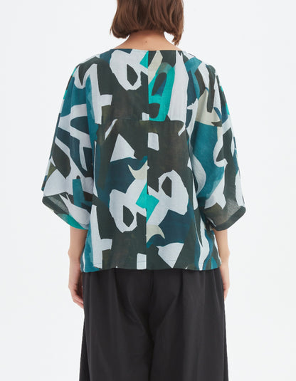 woman wearing abstract print boxy fit summer top in teals