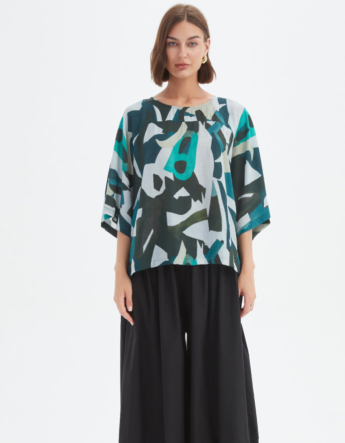 woman wearing abstract print boxy fit summer top in teals