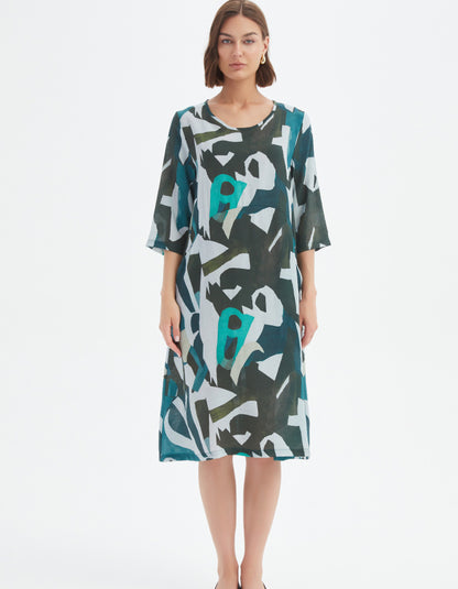 Woman wearing a patterned dress on a white background