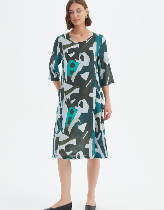 Woman wearing a patterned dress on a white background