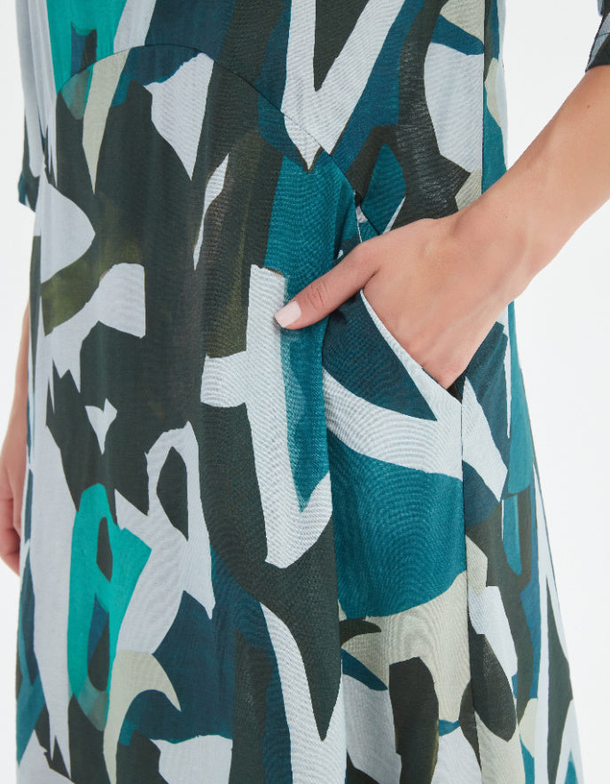 Close-up of a person wearing a patterned dress with abstract design.