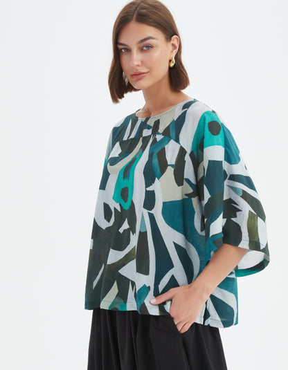 woman wearing abstract print boxy fit summer top in teals