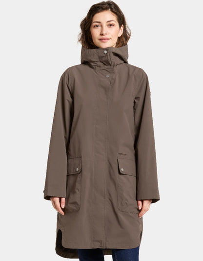 Woman wearing a mocha brown waterproof coat on a white background parka style