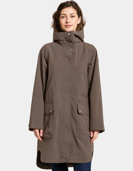 Woman wearing a mocha brown waterproof coat on a white background parka style