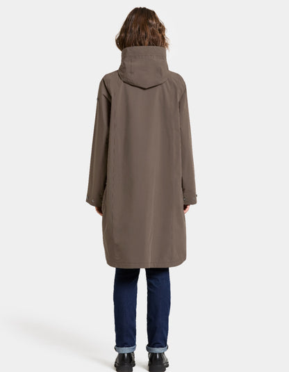 Woman wearing a mocha brown waterproof coat on a white background parka style