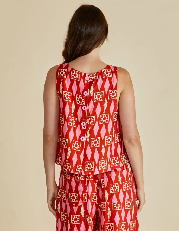 Red patterned dress worn by a person on a beige background