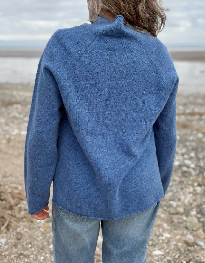 woman wearing lambswool merino turtle neck sweater in denim blue