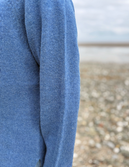 woman wearing lambswool merino turtle neck sweater in denim blue