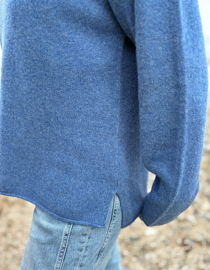 woman wearing lambswool merino turtle neck sweater in denim blue