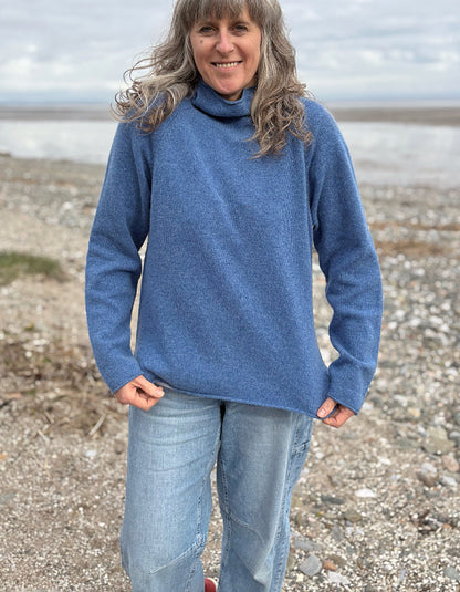 woman wearing lambswool merino turtle neck sweater in denim blue