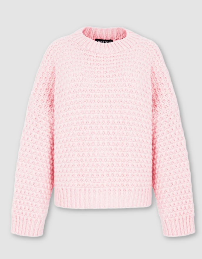 A light pink textured knit sweater with a crew neck, shown against a neutral light gray background.