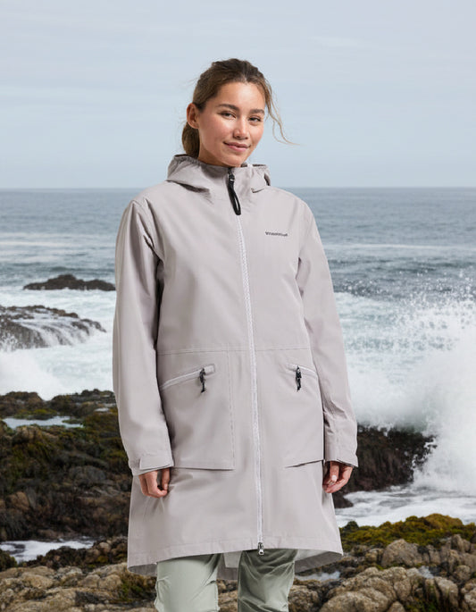 woman wearing pale pink raincoat